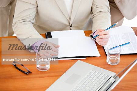 Close-up of a businessman working in a meeting with his team