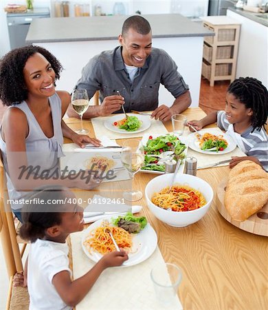 Happy family dining together in the kitchen