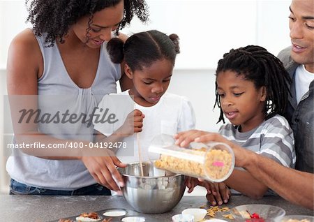 Ethnic family making biscuits together in the kitchen