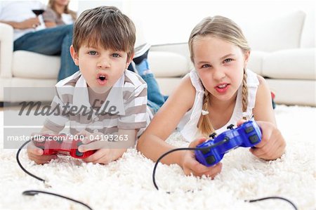 Animated children playing video games lying on the floor