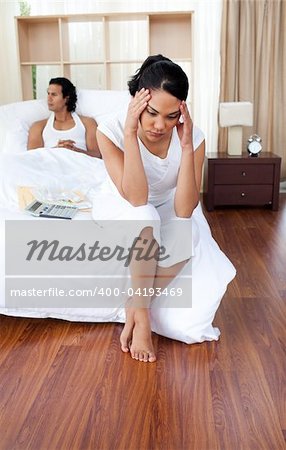 Portrait of a angry couple sitting on the bed after having a row