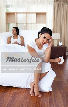 Young woman getting fed up with her boyfriend in the bedroom