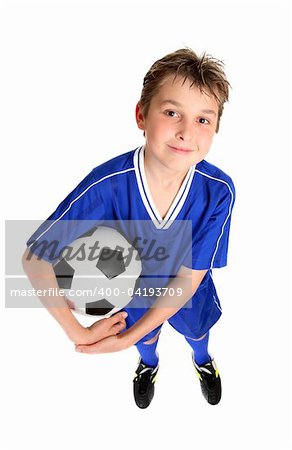 A smiling boy in soccer uniform ready for a game of soccer.  White background.