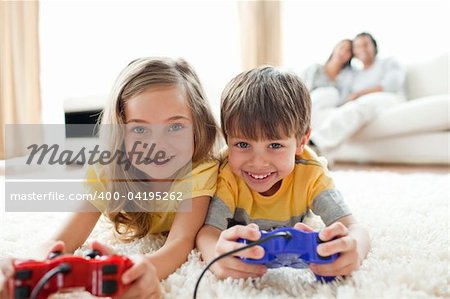 Loving siblings playing video game in the living room