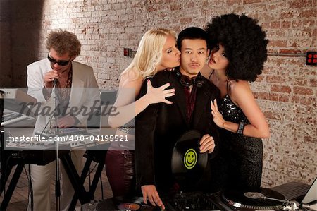 Asian DJ with fangirls kissing his cheek