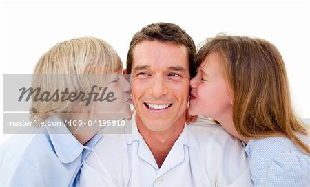 Cute siblings kissing their father against a white background