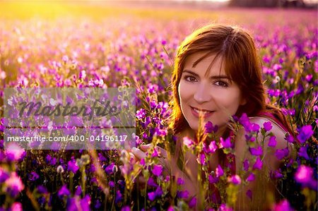 Beautiful young woman portrait on a flowery meadow