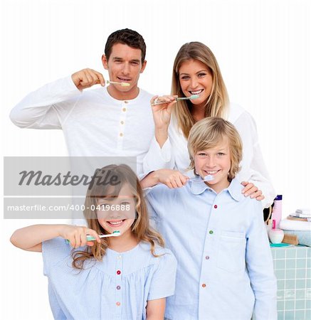 Merry family brushing their teeth in the bathroom at home