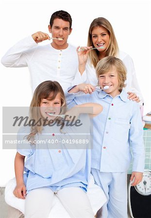 Jolly family brushing their teeth  in the bathroom