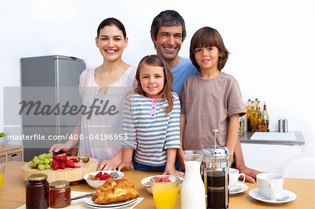 Happy family having a breakfast in the kitchen