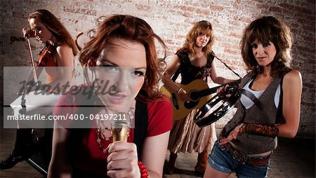 All-girl band performing in stylish clothing at a warehouse