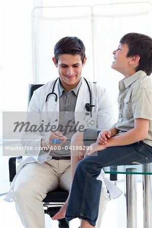 Confident male doctor checking a patient's reflex during a medical visit