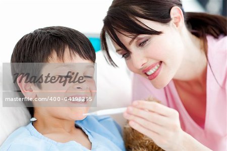 Positive nurse and his patient looking at a thermometer in a hospital