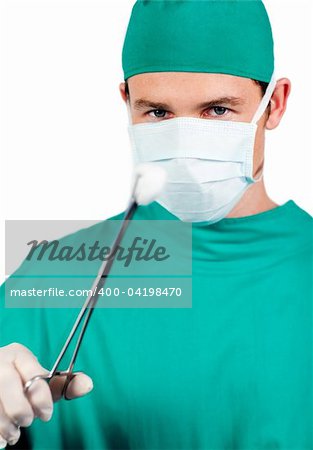 Self-assured male surgeon holding surgical forceps against a white background