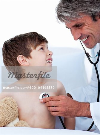 Mature male doctor checking little boy's pulse in a hospital