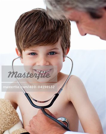 Attentive doctor playing with a little boy in a hospital