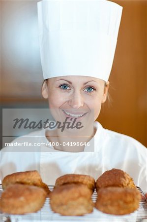 Charming young chef baking scones in the kitchen