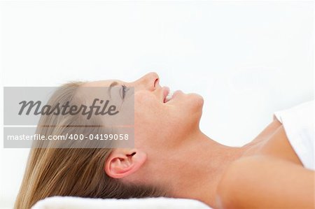 Portrait of pretty woman relaxing after a spa treatment against a white background