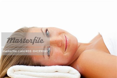 Portrait of charming woman relaxing after a spa treatment against a white background