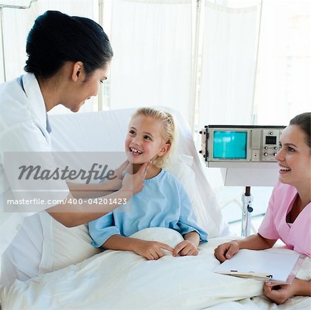 Smiling doctor attending a young patient in a hospital