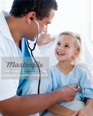 Male doctor examining a child patient in a hospital