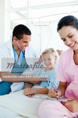 Smiling blond girl at a checkup in a hospital