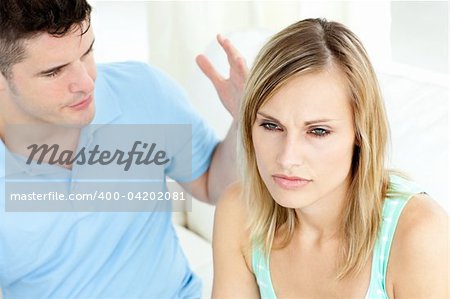 Young couple having an argue in the living-room at home