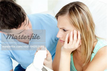 Tired couple having an argue in the living-room at home