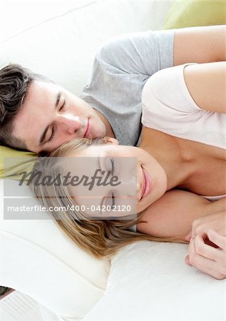Sleeping lovers having fun together on a sofa in the living-room