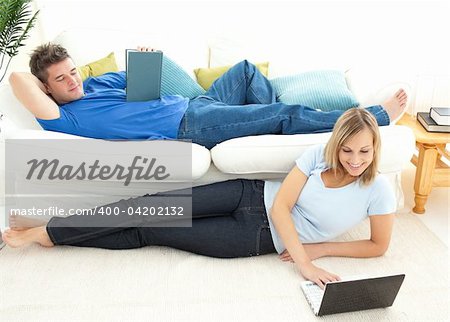 Cute couple having free time together in the living-room