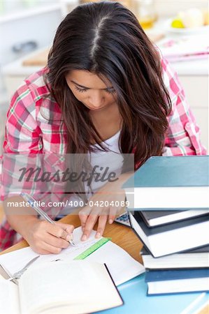 Young woman doing her homework at a table