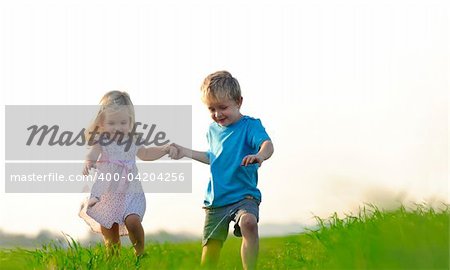 Brother and sister playing together in a field