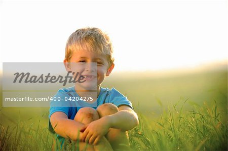 young boy enjoys his time outside in the field