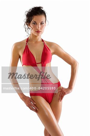 sensual woman brunette with sexy red swimsuit and hair style taking pose over white with wet skin