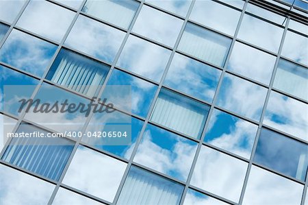 Detail of a modern office building with sky reflection