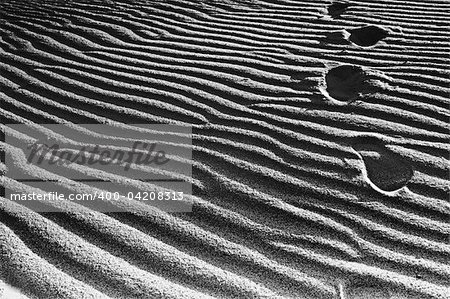 Footprints left behind in the sand.