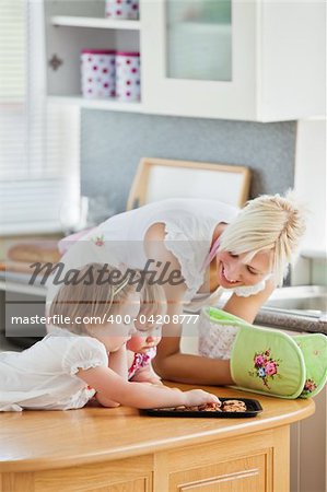 Blond mother having fun with her daughters in living room