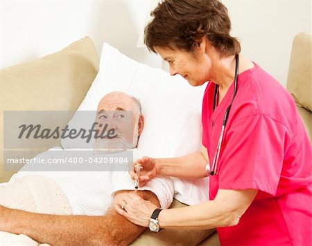 Home health nurse giving a shot to an elderly patient.