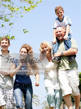 Happy family having fun in the park with three children