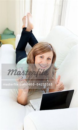 Animated woman with laptop and card on the sofa smiling at the camera at home