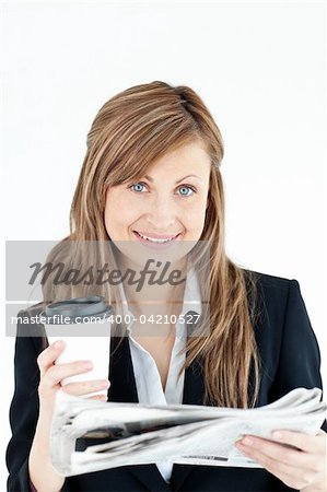 Elegant businesswoman reading newspaper holding coffee against white background