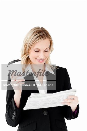 Beautiful businesswoman holding a cup of coffee reading a newspaper against a white background
