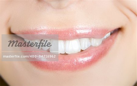 Smiling woman mouth with white teeth closeup
