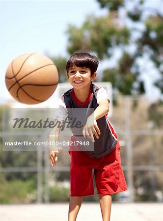 Young boy in action passing basketball