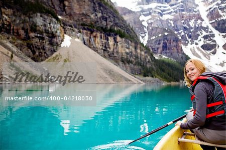 A woman canoeing on Moraine Lake, a tight crop with copy space