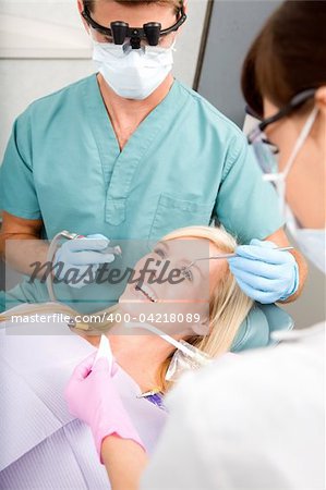 A woman at the dentist about to have some drilling done