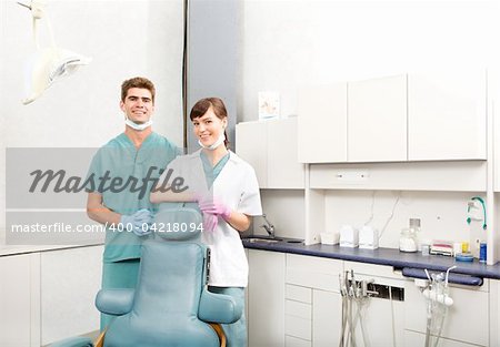 A portrait of a dental team in a clinic smiling at the camera
