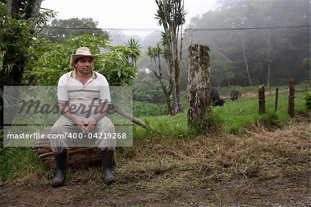 Wide angle shot of Costa Rican ranch hand by the side of the road
