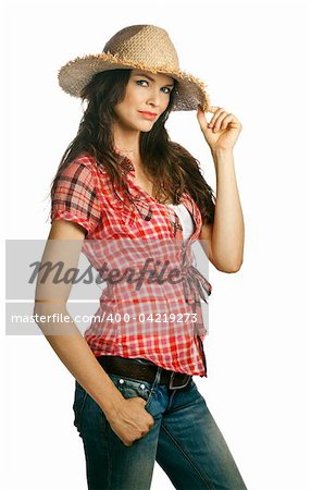 An isolated portrait of a beautiful young cowgirl with attitude holdinh her hat. Isolated over white.