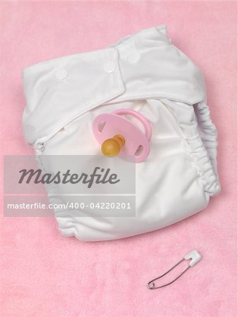 A modern cloth nappy isolated against a pink background